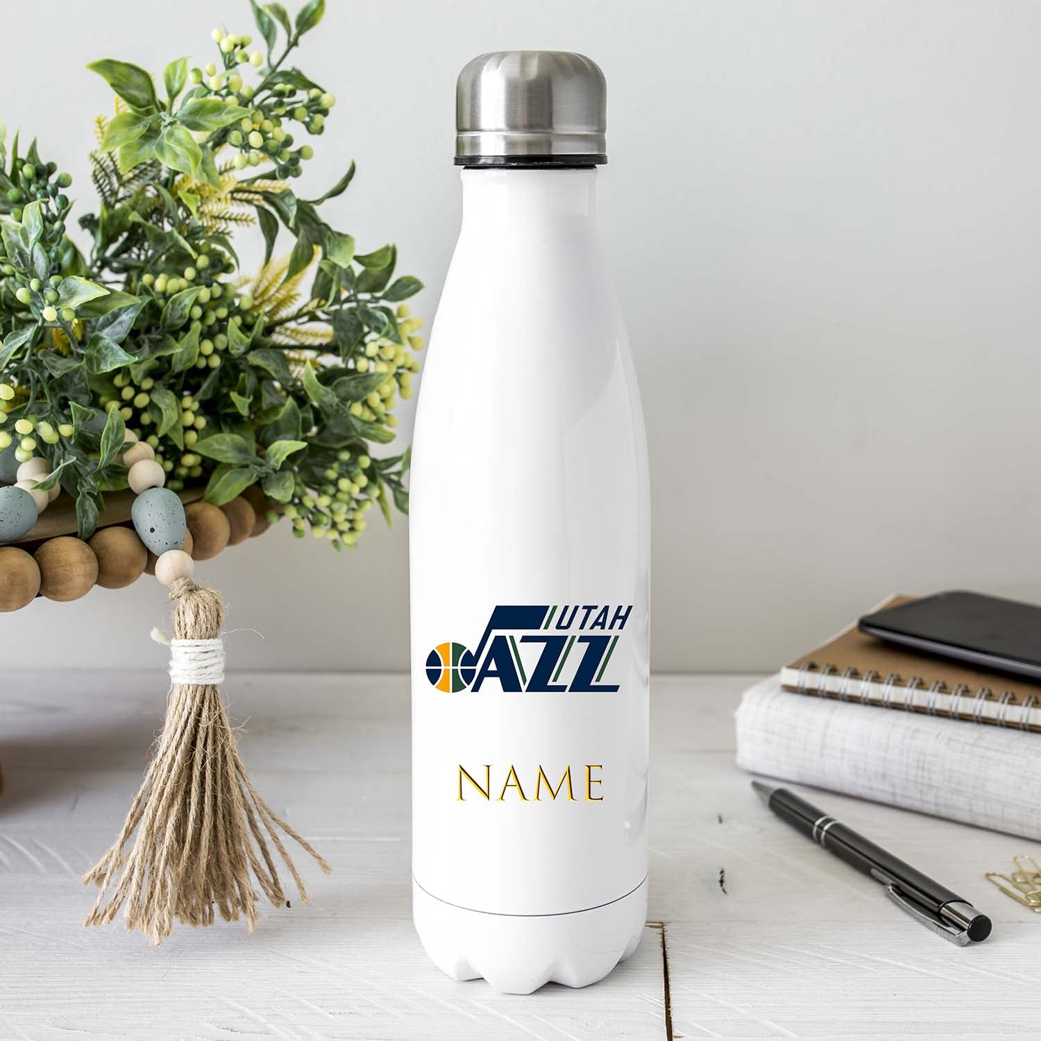 Bouteille isotherme personnalisée Utah Jazz – 500ml, en acier inoxydable, aux couleurs de l’équipe NBA. Personnalisation avec un prénom, design officiel, isolation thermique pour boissons chaudes et froides. Idéale pour le sport, le bureau et les déplacements.